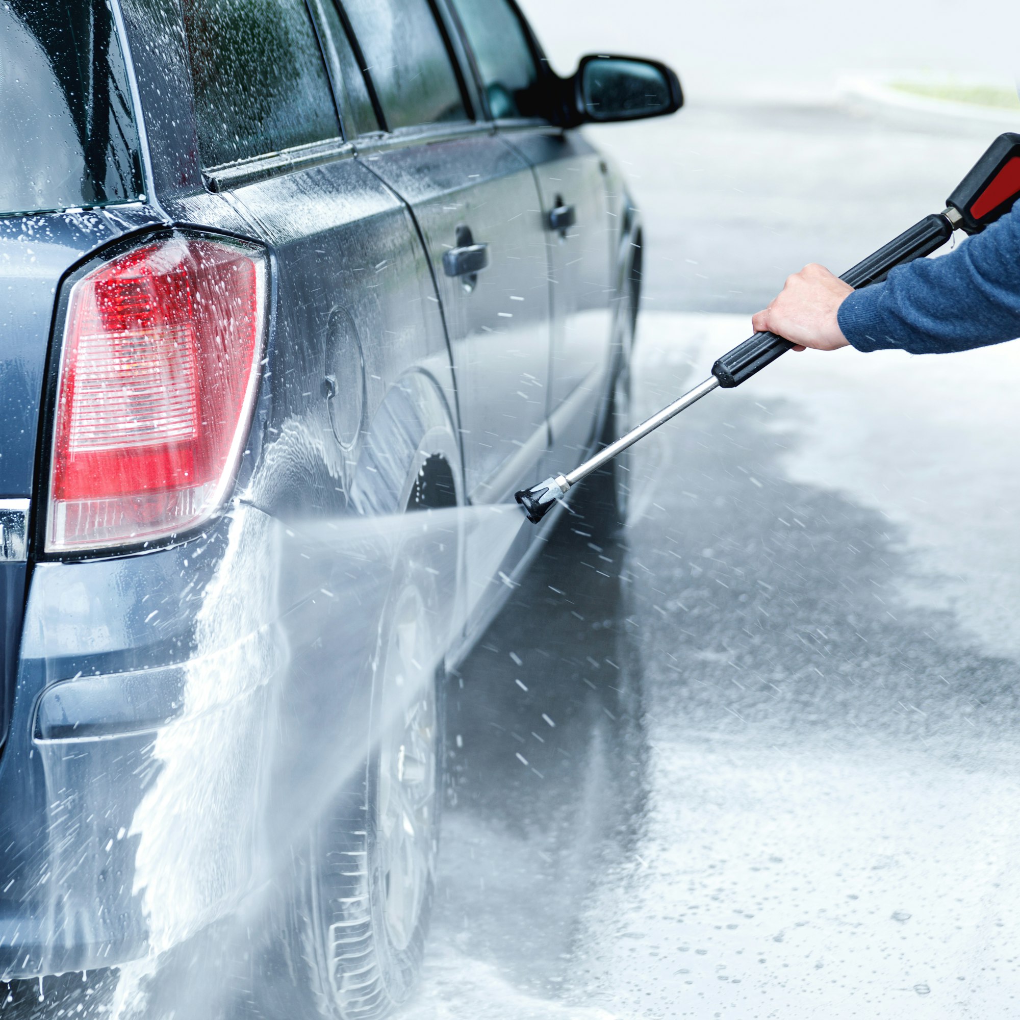 car wash worker is washing client s car