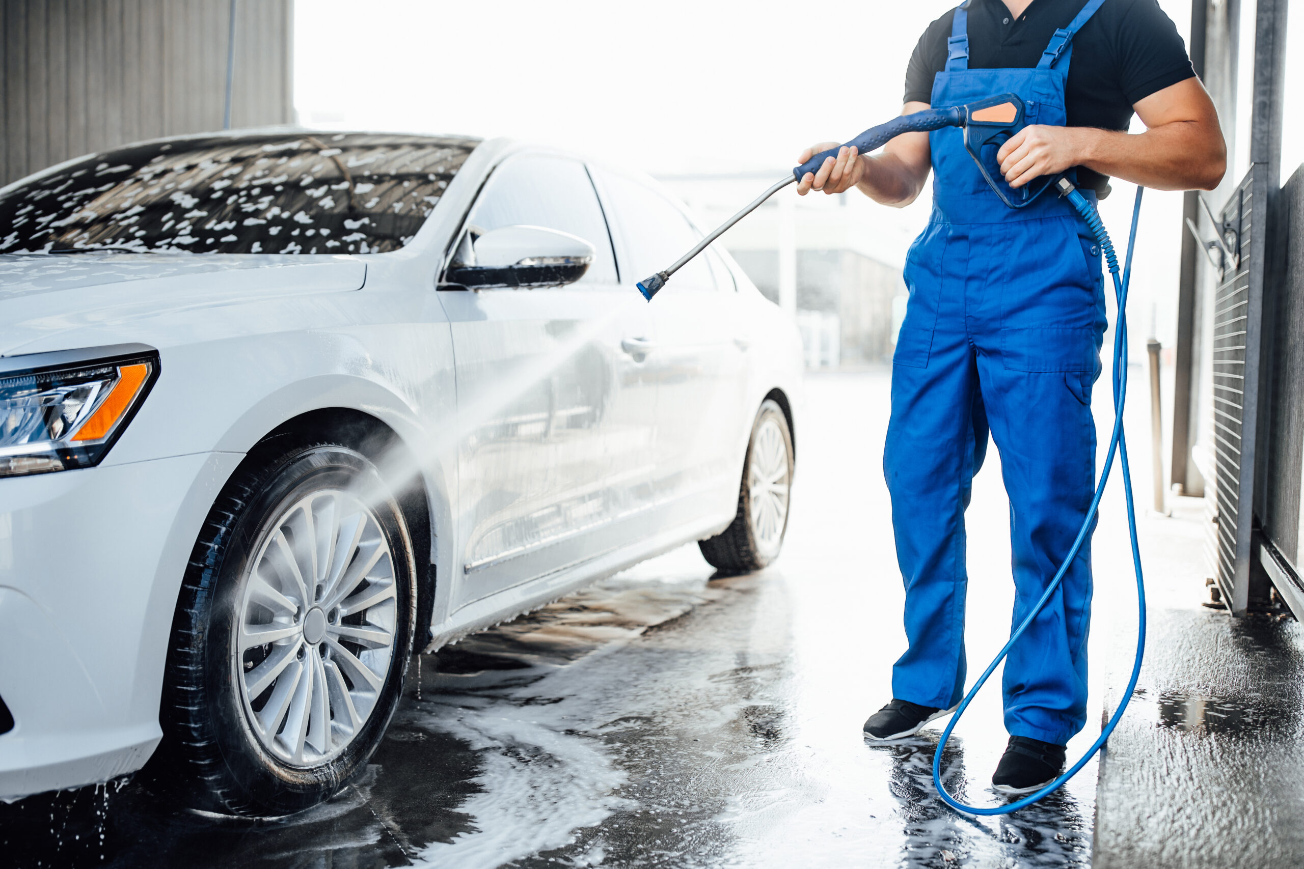 About Us 2 professional washer blue uniform washing luxury car with water gun open air car wash 1 scaled